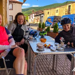 Female cyclist enjoying cafe break in Picos de Europa Northern Spain guided road cycling tour with Marmot Tours