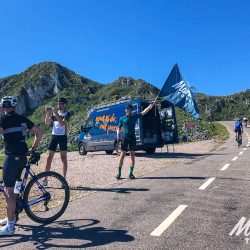 Group of cyclists celebrate at summit of Alto d l'Angliru in Picos de Europa Northern Spain with marmot Tours road cycling holidays and challenges
