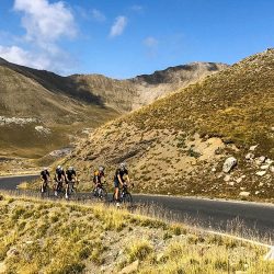 Group of cyclists enjoying high climb in Southern Alps on Marmot Tours fully supported road cycling holiday