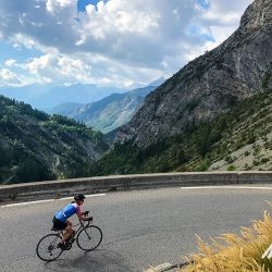 Female cyclist enjoying beautiful climb in Southern Alps on Marmot Tours fully supported road cycling holiday