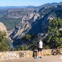 Cyclist admiring view of deep gorge on Marmot Tours guided road cycling holiday Mont Ventoux