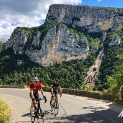 Pair of cyclist enjoying ride through gorge on Marmot Tours guided road cycling holiday Mont Ventoux Verdon Gorge France