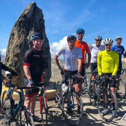 Group of cyclists smiling at Cold de la Bonette cycling climb Southern Alps with Marmot Tours