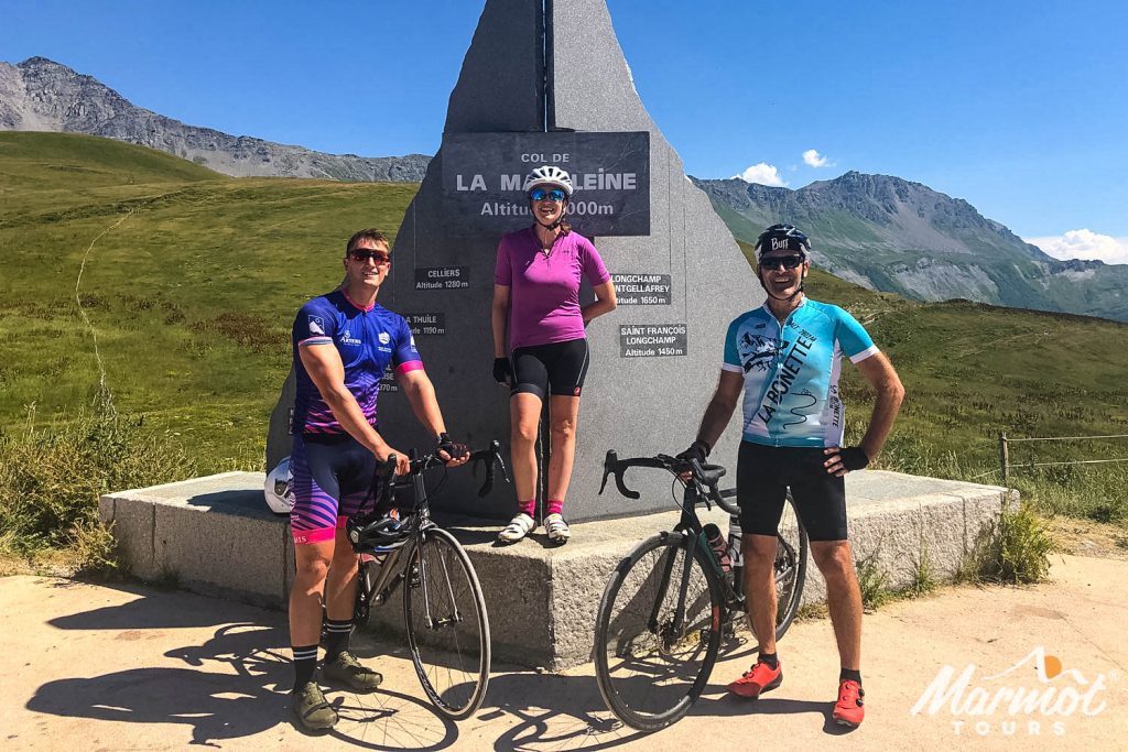 Trio of cyclists at Col de la Madeleine on Marmot Tours guided road cycling holiday in French Alps