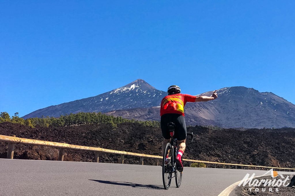 Cyclist giving thumbs up on a ride with Mount Teide in background on Marmot Tours guided road cycling holiday Tenerife