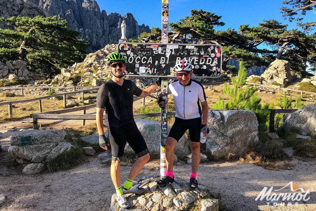 Pair of cyclists smiling at Col de Bavedda on guided road cycling tour of Corsica with Marmot Tours