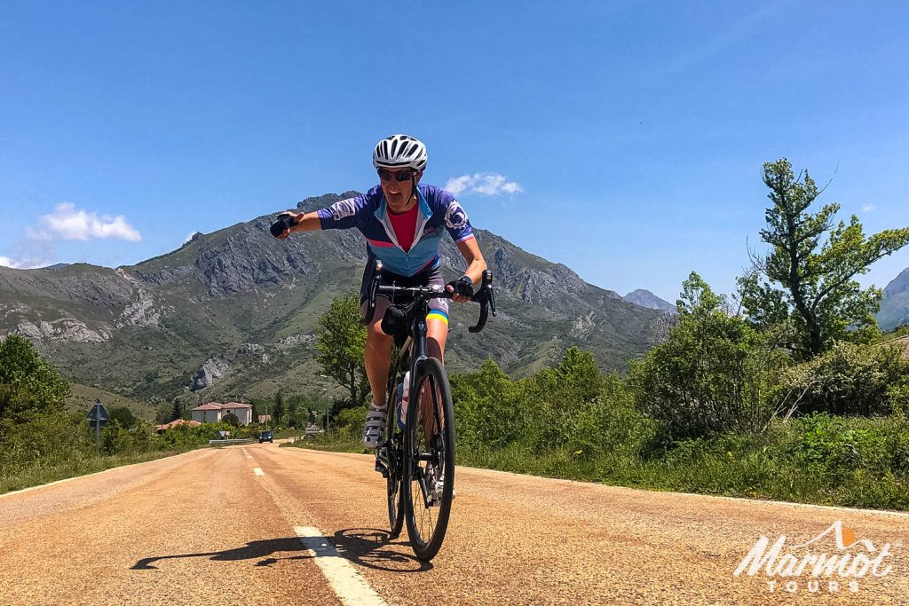 Female cyclist poking out tongue and thumbs up on guided cycling tour Picos d'Europa northern Spain with Marmot Tours