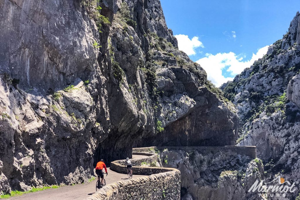 Pair of cyclist enjoy winding road through gorge on Marmot Tours full support road cycling tour of Pyrenees Foothills