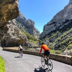 Pair of cyclists on gorge road with Marmot Tours in Foothills Pyrenees