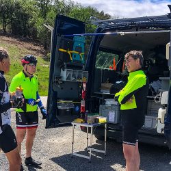 cyclists chatting at marmot tours support vehicle in foothills pyrenees