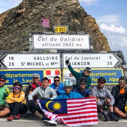 Group of cyclists celebrating at Col du Galibier on guided road cycling tour French Alps with Marmot Tours