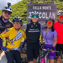 Group of cyclists smiling at summit of Monte Zoncolan on Marmot Tours guided road cycling holiday Slovenia