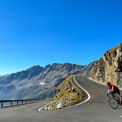 Cyclist descending hairpin bend of passo di gavia on Marmot Tours Raid Dolomites cycling challenge