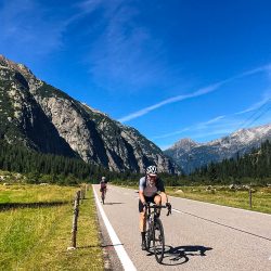 Pair of cyclists riding in Swiss Alps on guided road cycling holiday with Marmot Tours