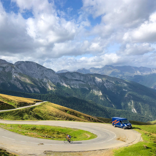 Cyclist climbing Col du Tourmalet with marmot tours support van nearby