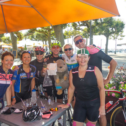 Group of cyclists celebrating finish of Raid Alpine with Marmot Tours guided road cycling holidays