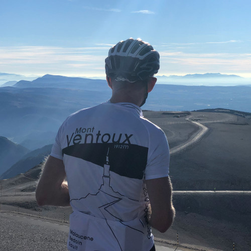 Cyclist on Marmot Tours holiday viewing landscape from summit of Mont Ventoux