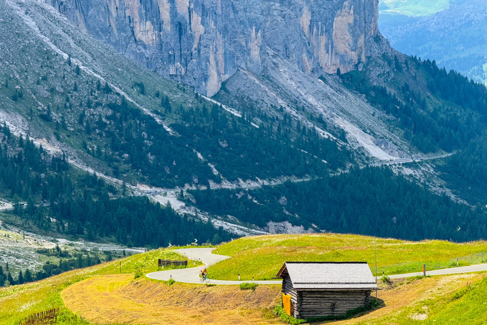 cyclist riding pass in Italian dolomites with towering limestone columns on marmot tours road cycling holiday