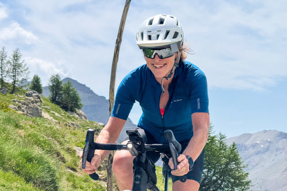 close up image of smiling female cyclist on Italian dolomites cycling holiday with marmot tours