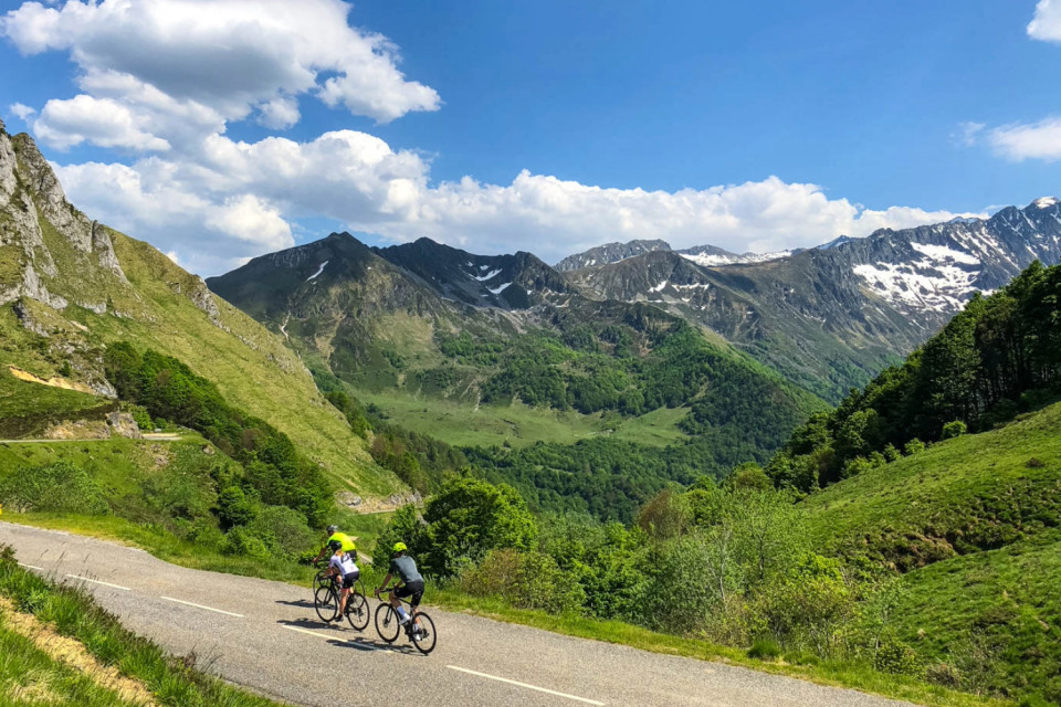 three cyclists descend col d'ages on French pyrenees cycling challenge with marmot tours