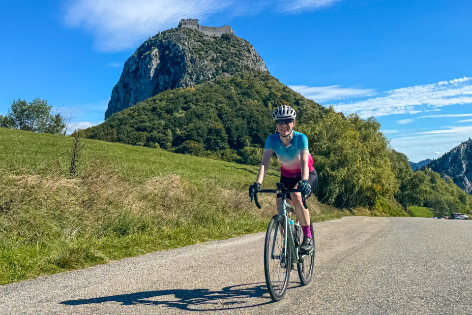cyclist summiting col de montsegur on pyrenees foothills holiday with marmot tours