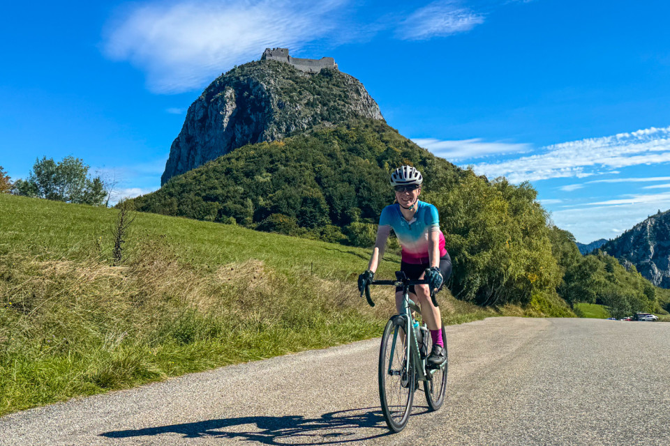 cyclist summiting col de montsegur in pyrenean foothills on marmot tours French cycling holiday