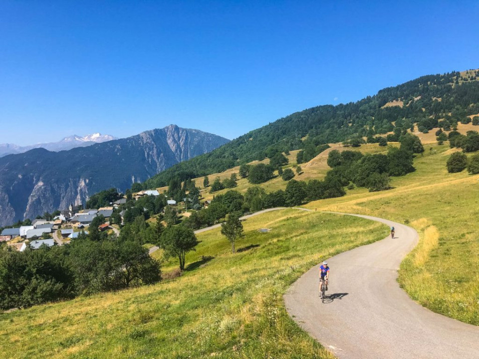 Cyclist enjoying Alpine scenery on short road cycling break with Marmot Tours