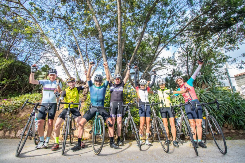 Group of excited cyclists at start of Corsica cycling holiday with Marmot Tours
