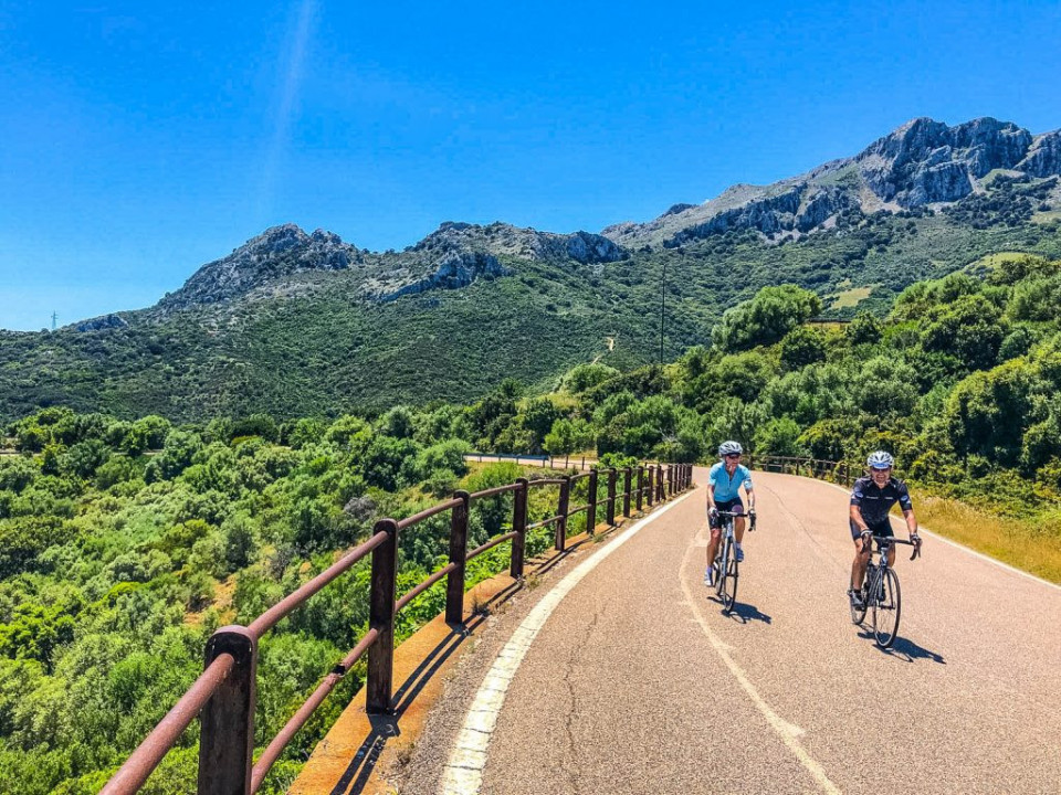 Pair of cyclists climbing Col de Vergio on Marmot Tours guided road cycling holiday in Corsica