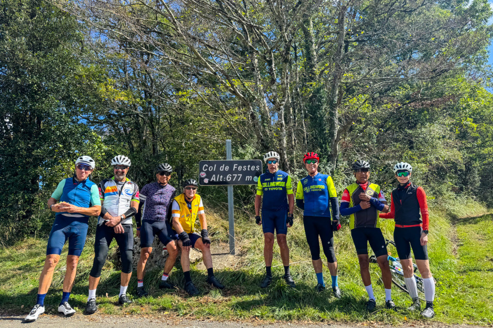 group of cyclists pose at col de fester on pyrenees foothills cycling holiday with marmot tours