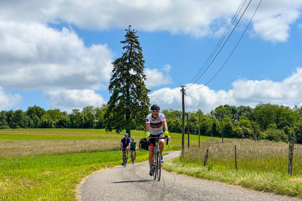cyclists climbing rural road in pyrenean foothills on marmot tours cycling holiday