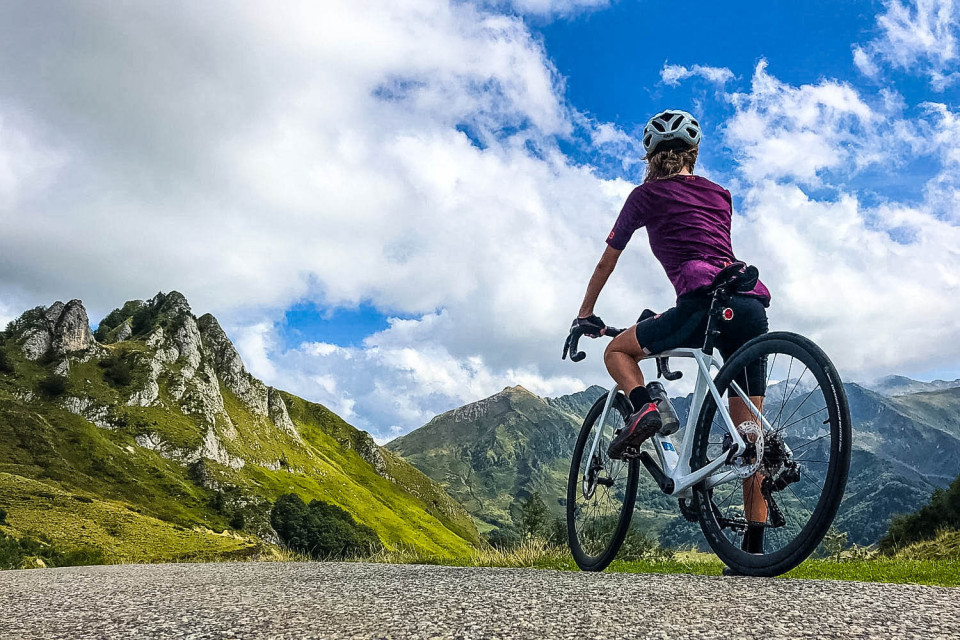 Cyclist pausing to look at mountains in Pyrenees on Marmot Tours guided road cycling holiday