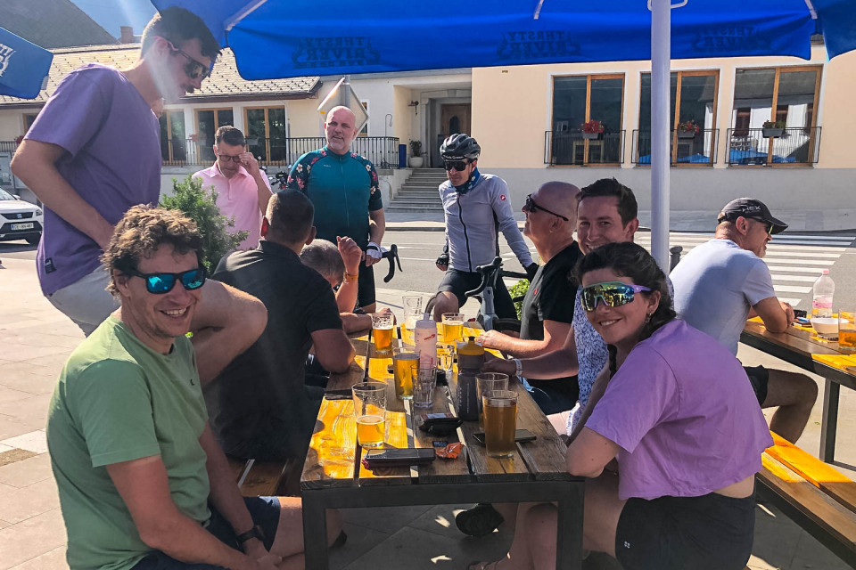 Group of cyclists enjoying drinks on bar terrace on Slovenia cycling holiday with Marmot Tours