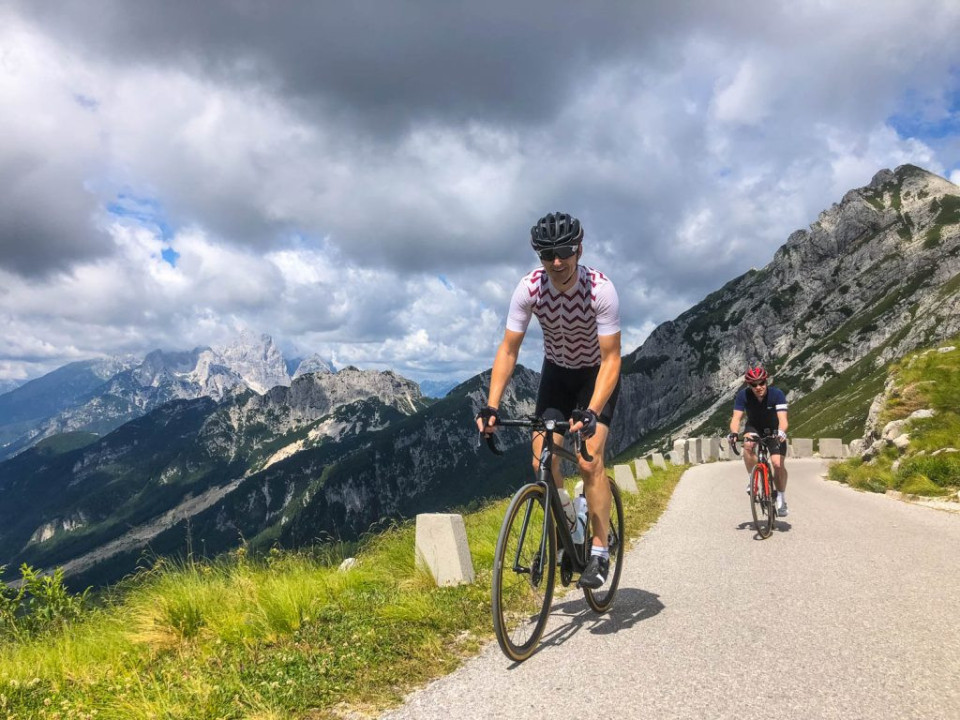 Two cyclists climbing Mangart Saddle Slovenia cycling holiday with Marmot Tours