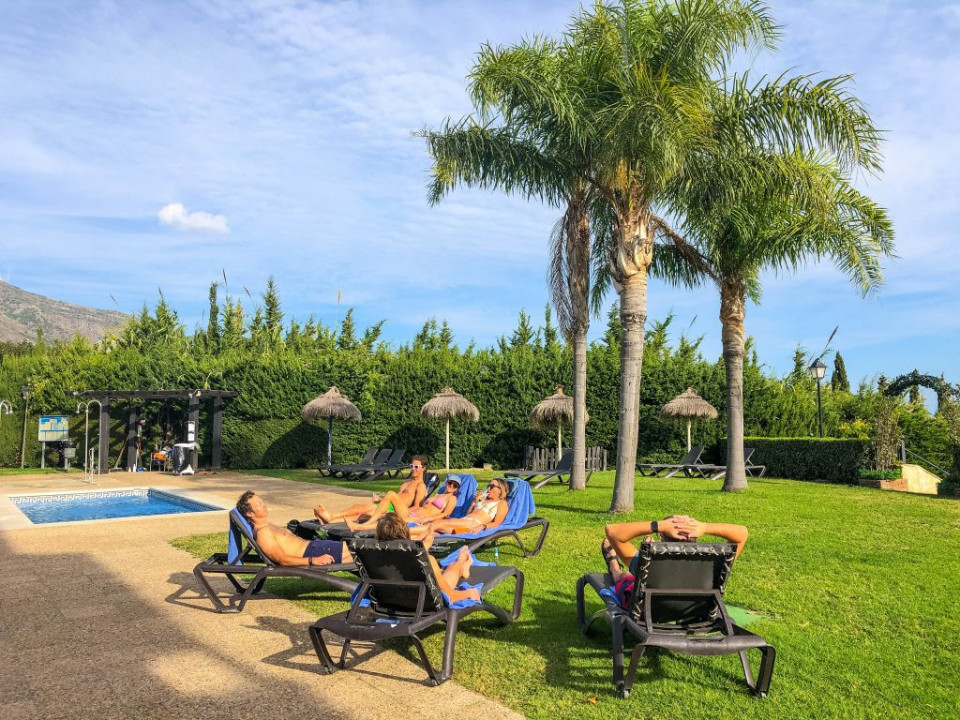 Cyclists relaxing by pool on guided road cycling holiday Andalusia Spain with Marmot Tours
