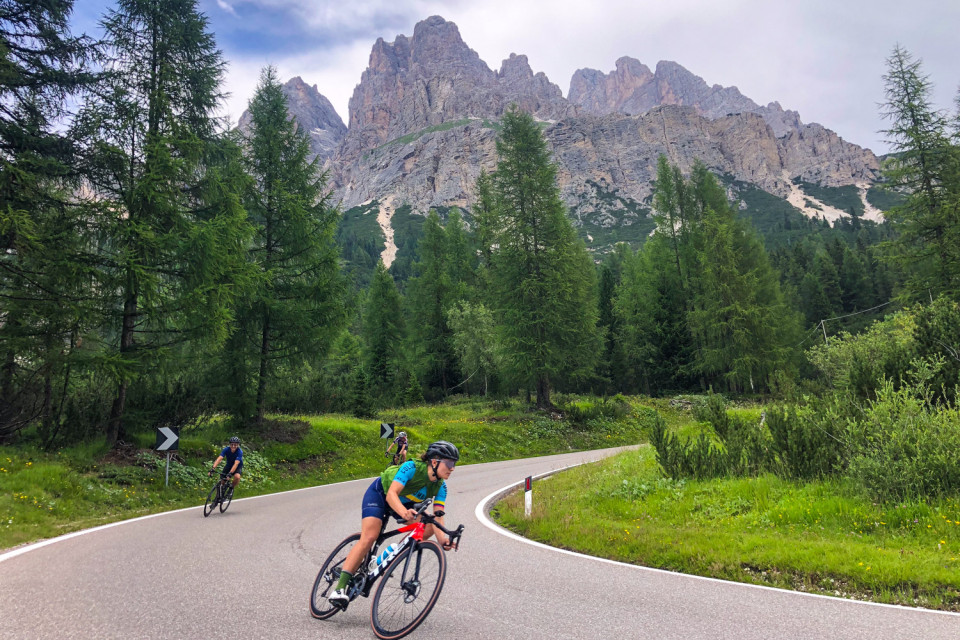 cyclists descending mountain pass in Italian dolomites on guided road bike tour with marmot tours