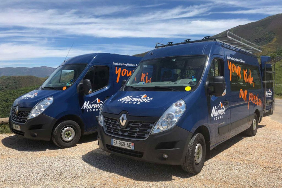 Pair of liveried support vans Marmot Tours guided road cycling holidays in Europe