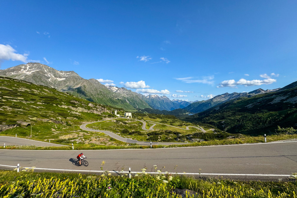 Cyclist climbing san Bernardino pass on marmot tours guided road cycling holiday Italy