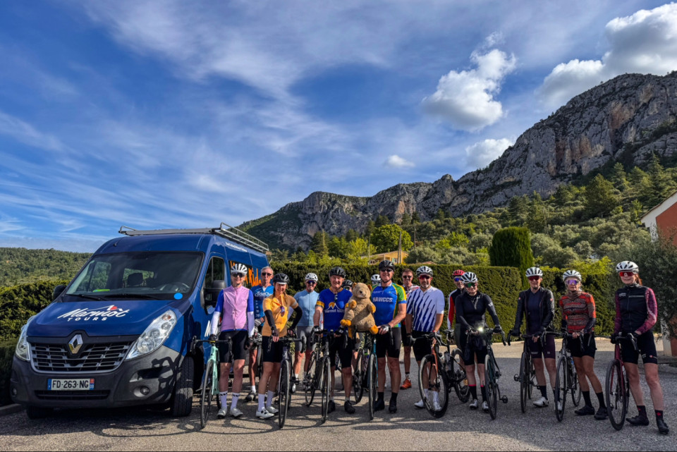 group of cyclists and marmot tours support vehicle with rocky outcrop backdrop on mont Ventoux cycling holiday
