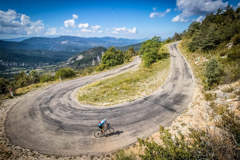 Cyclist enjoying peaceful climb to Col du Perty on Marmot Tours guided road cycling tour Mont Ventoux Provence France