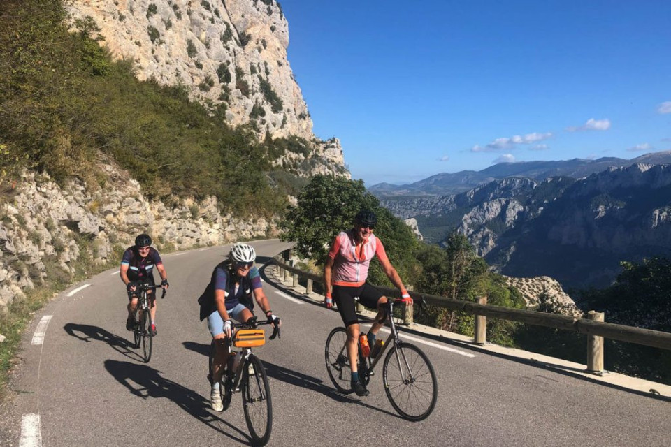 Cyclists enjoying Verdon Gorge cliff road on Marmot Tours guided road cycling tour Mont Ventoux Provence France