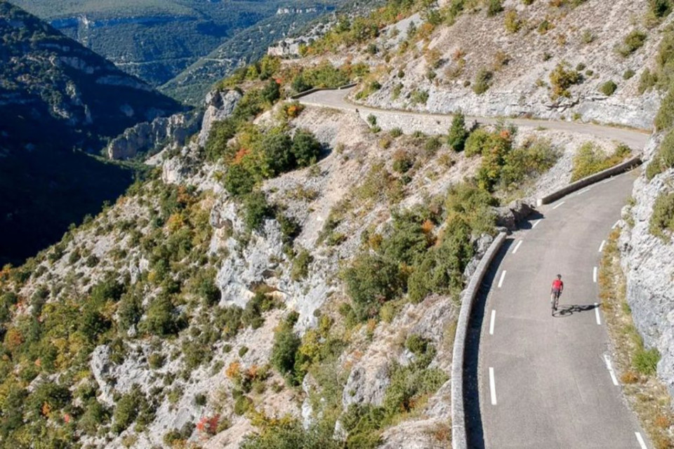 Cyclist on quiet road through Gorge de la Nesque on marmot Tours guided road cycling tour Mont Ventoux Provence France