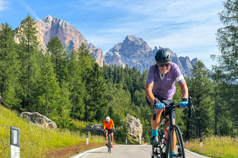 cyclists approach camera climbing passo giau on Italian dolomites road cycling holiday with marmot tours