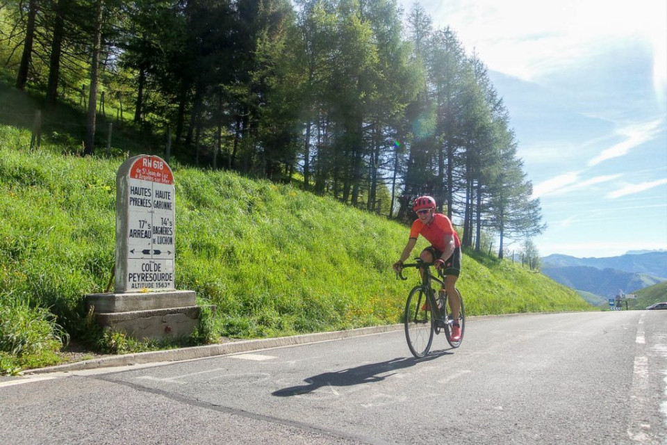 Cyclist summiting the Peyresourde from Bagneres de Luchon with Marmot Tours on the Classic Cols of the Pyrenees road cycling holiday