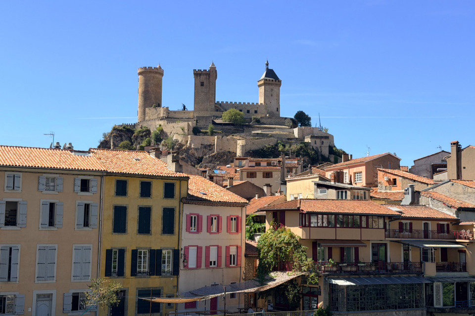 Foix castle on hilltop with medieval streets below