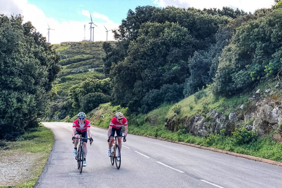 Pair of cyclists enjoying an early climb on Raid Corsica with Marmot Tours