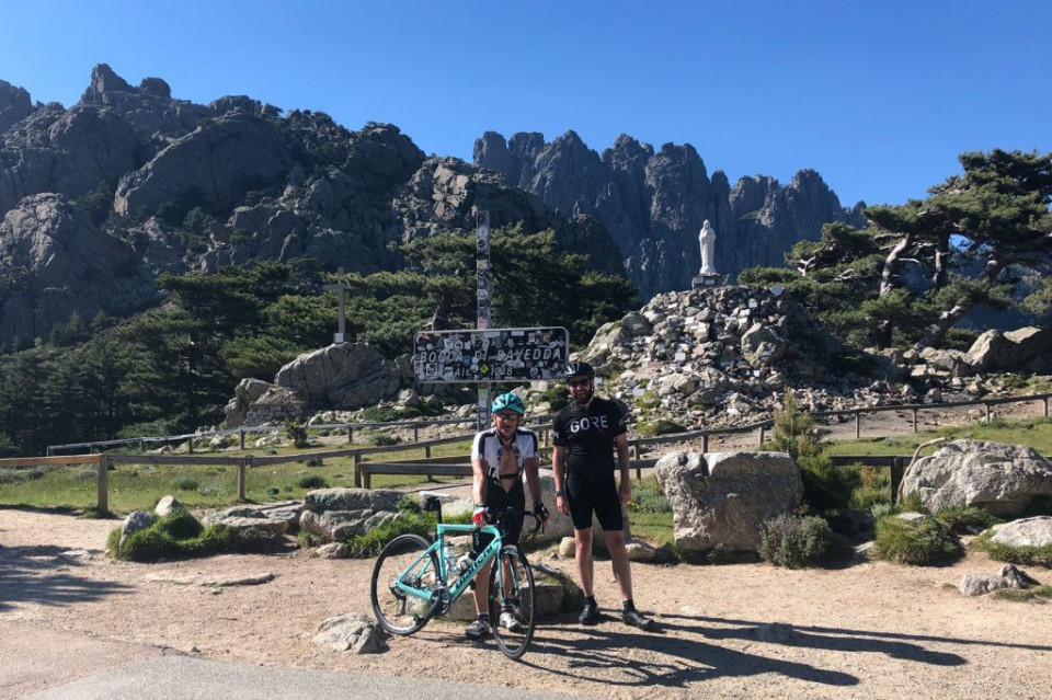 Pair of cyclists smiling at the Col de Bavella Bocca di Bavedda climb on Corsica with Marmot Tours guided road cycling holidays