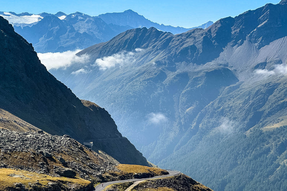 Mountains and valley with snaking road on Raid Dolomites cycling challenge with Marmot Tours