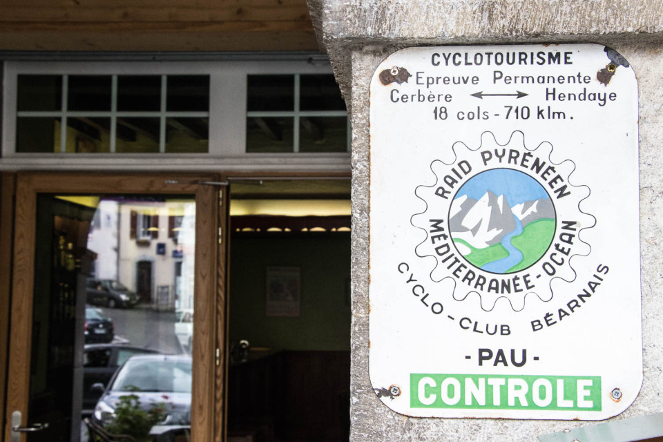 official raid pyrenees cycling sign on wall