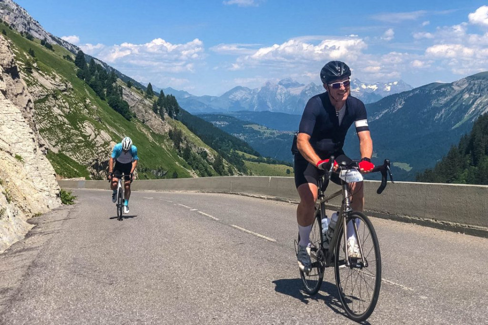 Two cyclist putting in the effort on a climb on Day 1 of Marmot Tours Raid Alpine cycling challenge French Alps